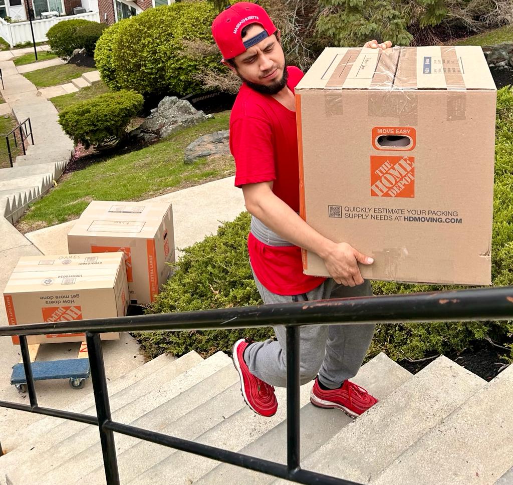 Professional mover carrying a protected moving box
